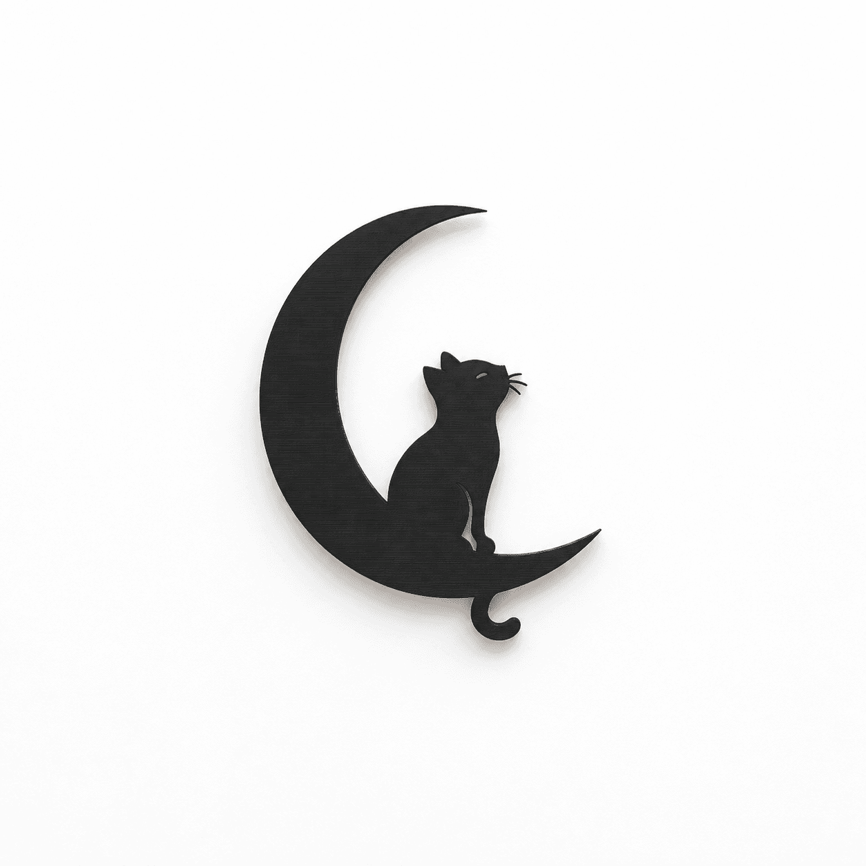 Black 3D printed cat on a crescent moon on a clean white background